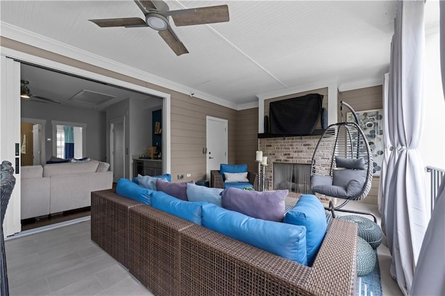 living room featuring a brick fireplace, ceiling fan, and ornamental molding