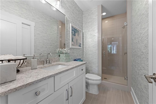 bathroom featuring toilet, tile patterned floors, a shower stall, and vanity