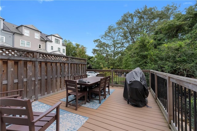 deck featuring outdoor dining area and area for grilling