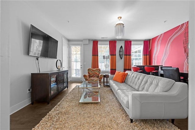 living room with dark wood-type flooring and baseboards