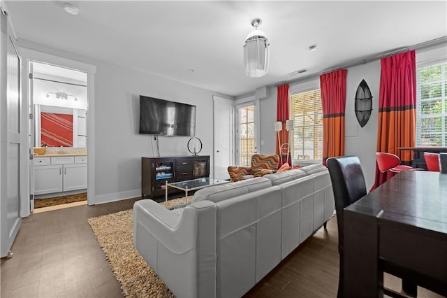 living area featuring visible vents and baseboards