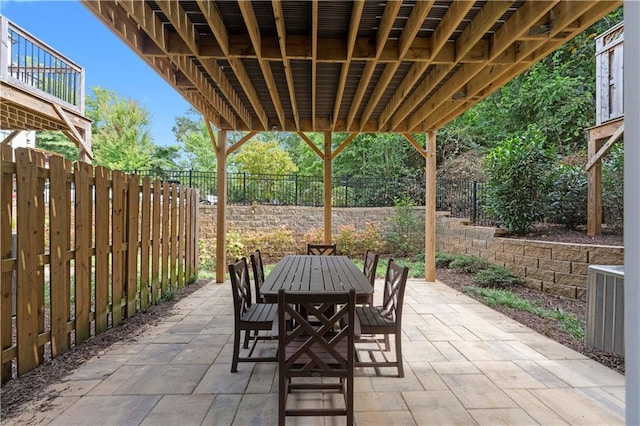 view of patio / terrace with outdoor dining space, cooling unit, and fence