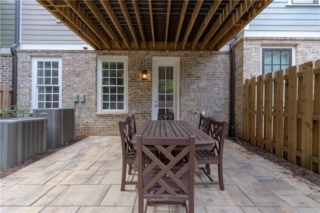 view of patio / terrace with fence, central AC, and outdoor dining space