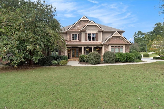 craftsman inspired home with a front yard and a porch