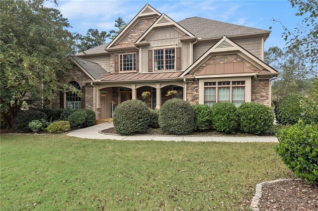 craftsman-style house with a front lawn and covered porch