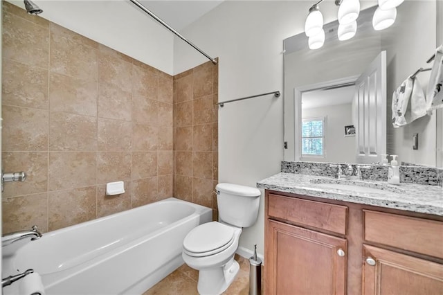 bathroom with tile patterned floors, toilet, vanity, and  shower combination