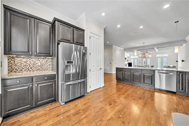 kitchen with stainless steel appliances, light wood-style flooring, recessed lighting, decorative backsplash, and ornamental molding