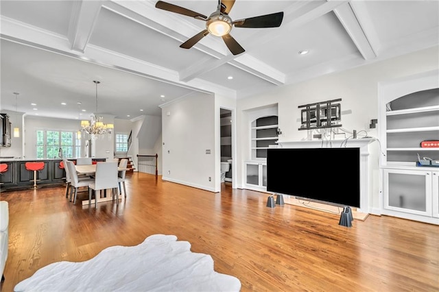 living room featuring wood finished floors, ceiling fan with notable chandelier, beamed ceiling, coffered ceiling, and recessed lighting