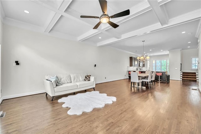 living room featuring dark wood-style floors, coffered ceiling, visible vents, baseboards, and ceiling fan with notable chandelier