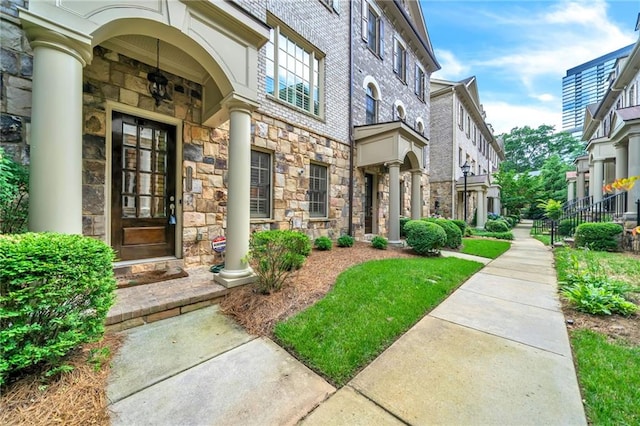 property entrance featuring stone siding