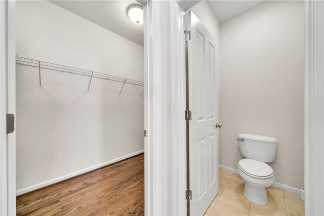 bathroom with baseboards and toilet