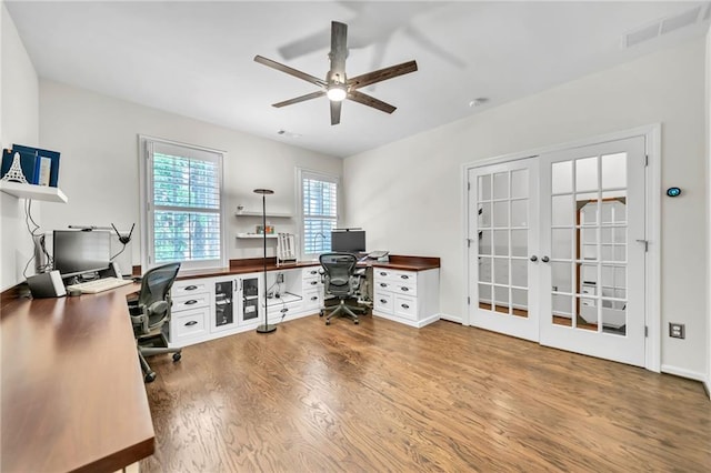 office space featuring wood finished floors, french doors, visible vents, and ceiling fan