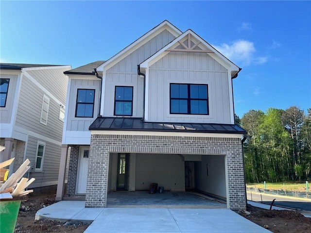 1075 Crest Mill Dr, Marietta, GA 30008 - view of front of home with brick siding, concrete driveway, board and batten siding, a standing seam roof, and an attached garage