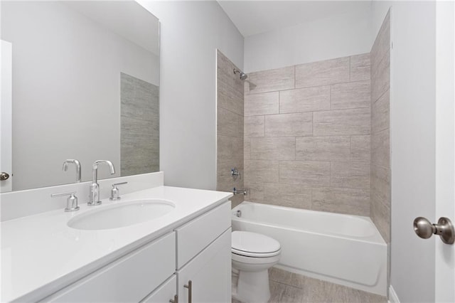 full bathroom with tiled shower / bath, toilet, tile patterned floors, and vanity