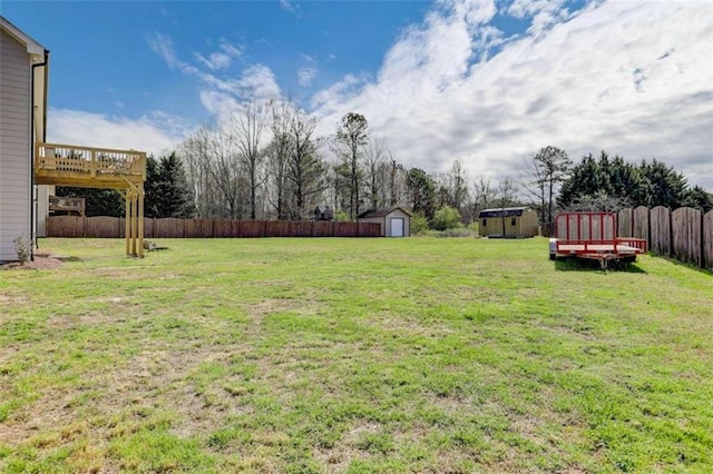 view of yard featuring a shed and a wooden deck