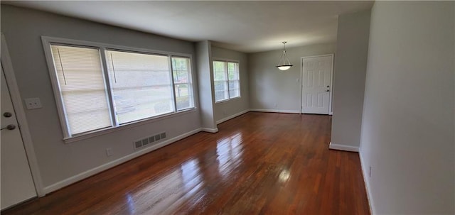 unfurnished room with dark wood-type flooring