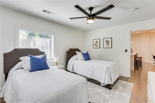 bedroom with ceiling fan and light wood-type flooring