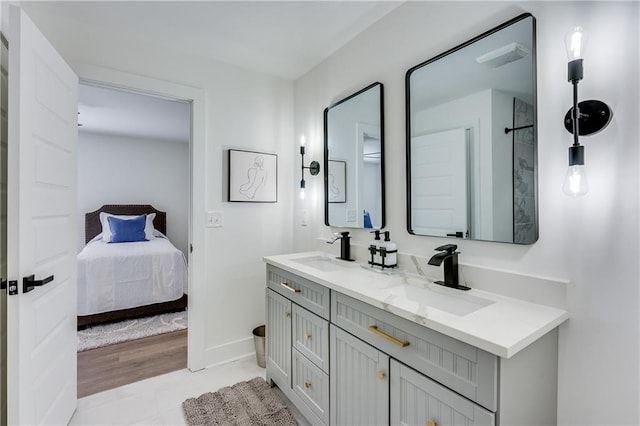 bathroom featuring walk in shower, vanity, and wood-type flooring