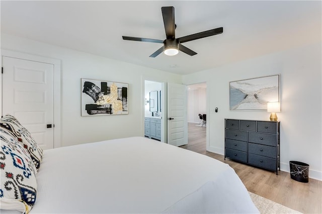 bedroom with ensuite bathroom, ceiling fan, and light hardwood / wood-style floors