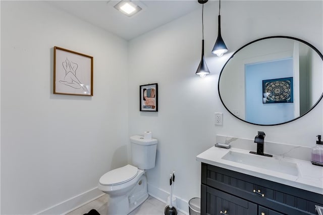 bathroom featuring tile patterned flooring, vanity, and toilet