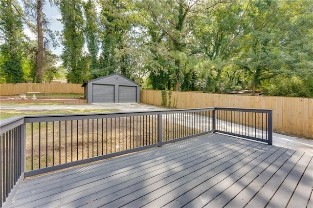 wooden terrace featuring a garage and an outbuilding