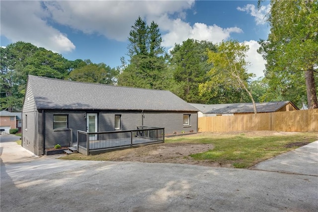 exterior space featuring a front yard and a deck