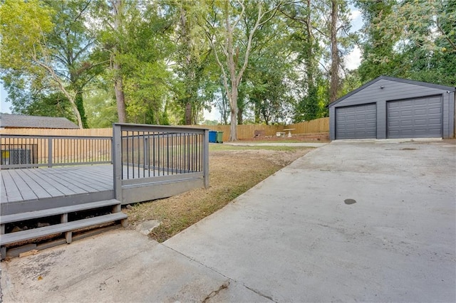 view of yard with a garage, an outdoor structure, and a deck