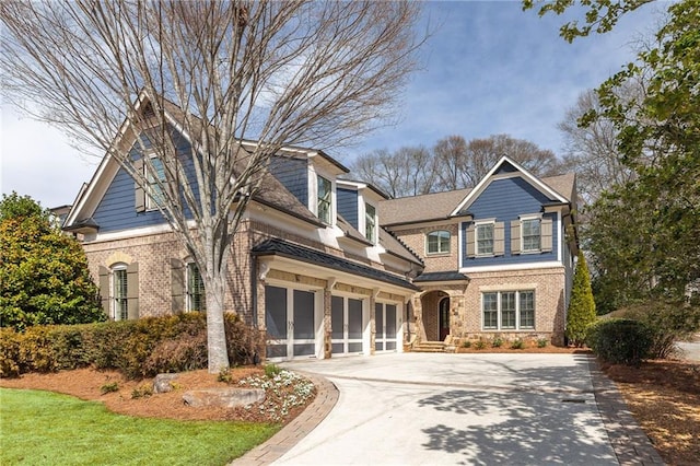 view of front facade featuring an attached garage, brick siding, and driveway