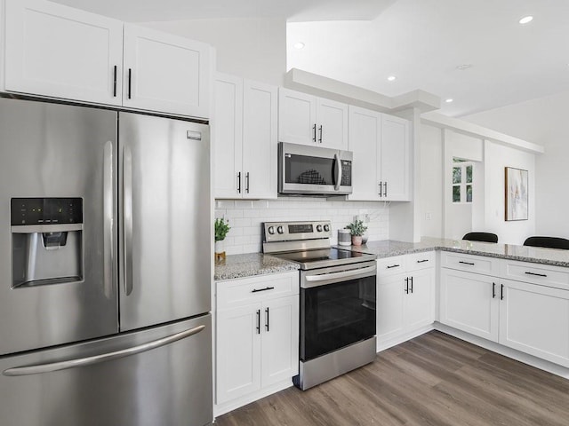 3100 Mount Gilead Rd SW, Atlanta, GA 30311 - kitchen featuring stainless steel appliances, white cabinetry, light stone countertops, backsplash, and recessed lighting