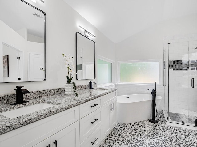 3100 Mount Gilead Rd SW, Atlanta, GA 30311 - full bath featuring a shower stall, double vanity, a freestanding bath, vaulted ceiling, and tile patterned floors