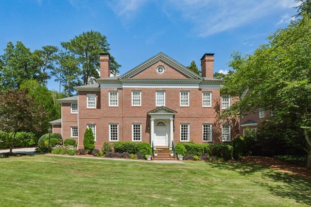 2671 Bohler Rd NW, Atlanta, GA 30327 - colonial inspired home with a chimney, a front lawn, and brick siding