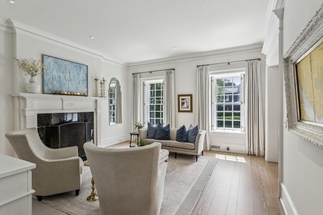 2671 Bohler Rd NW, Atlanta, GA 30327 - living area featuring a premium fireplace, light wood-style flooring, and ornamental molding