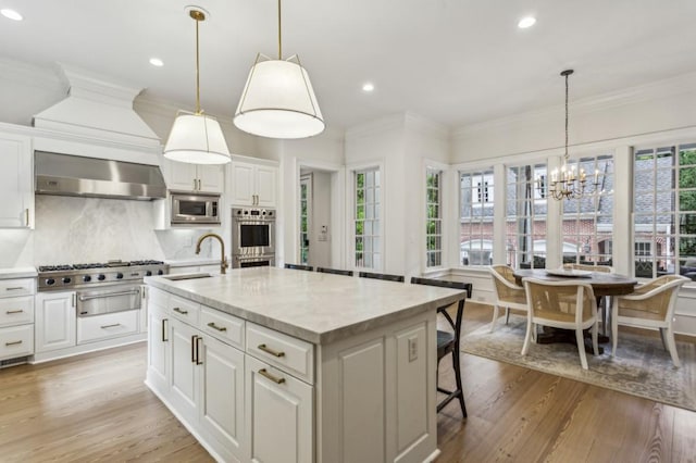 2671 Bohler Rd NW, Atlanta, GA 30327 - kitchen featuring exhaust hood, a chandelier, plenty of natural light, white cabinets, and recessed lighting