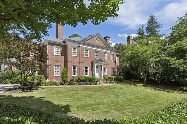 2671 Bohler Rd NW, Atlanta, GA 30327 - colonial-style house with a chimney, a front lawn, and brick siding