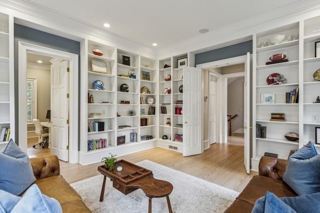 2671 Bohler Rd NW, Atlanta, GA 30327 - living room featuring crown molding, light wood-type flooring, built in shelves, and recessed lighting