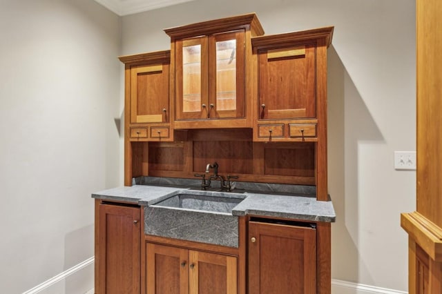 2671 Bohler Rd NW, Atlanta, GA 30327 - kitchen featuring glass insert cabinets, brown cabinets, and crown molding