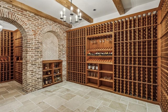 2671 Bohler Rd NW, Atlanta, GA 30327 - wine area featuring beam ceiling, stone tile flooring, a chandelier, and brick wall