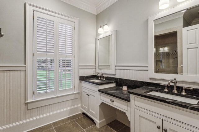 2671 Bohler Rd NW, Atlanta, GA 30327 - full bathroom featuring ornamental molding, double vanity, wainscoting, tile patterned flooring, and tiled shower