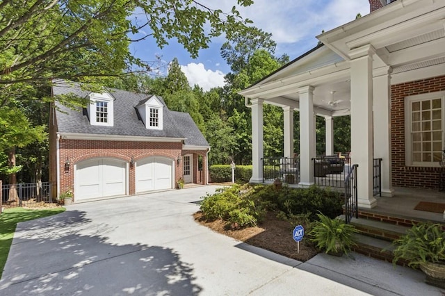 2671 Bohler Rd NW, Atlanta, GA 30327 - view of yard featuring covered porch, concrete driveway, an attached garage, and an outbuilding