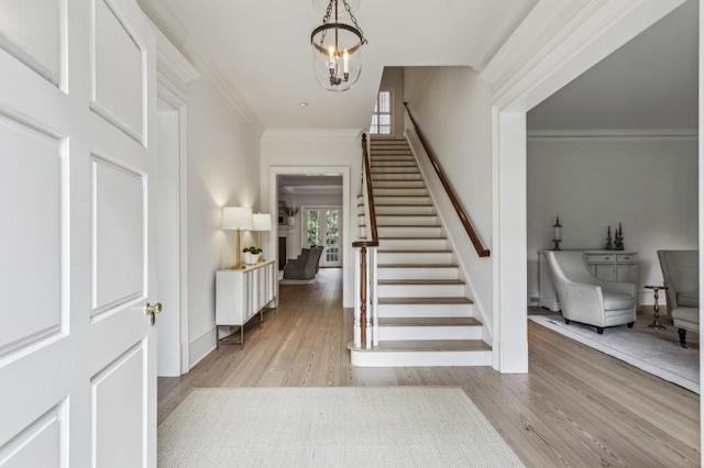 2671 Bohler Rd NW, Atlanta, GA 30327 - foyer featuring stairway, light wood-style floors, a chandelier, and crown molding