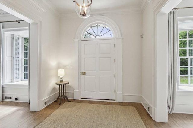 2671 Bohler Rd NW, Atlanta, GA 30327 - entryway with wood finished floors, plenty of natural light, ornamental molding, and a chandelier