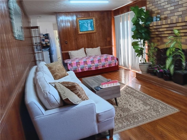 living room with wood-type flooring and wooden walls