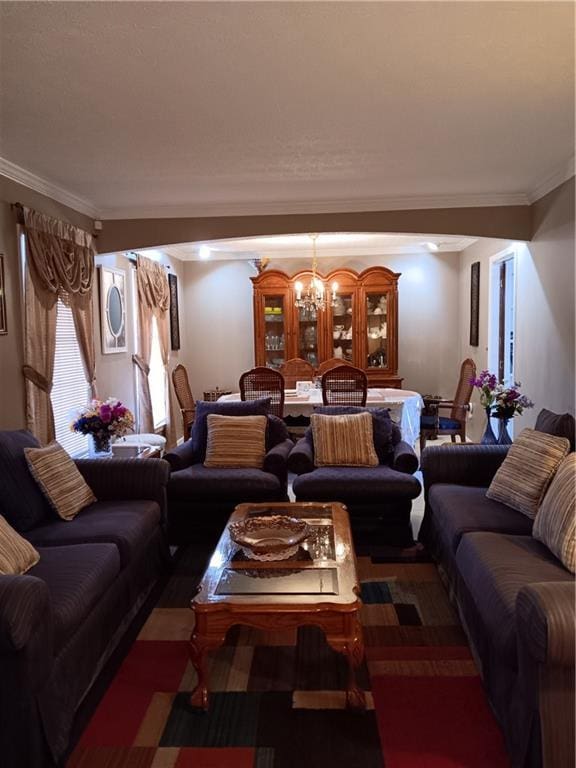 living room featuring crown molding and an inviting chandelier