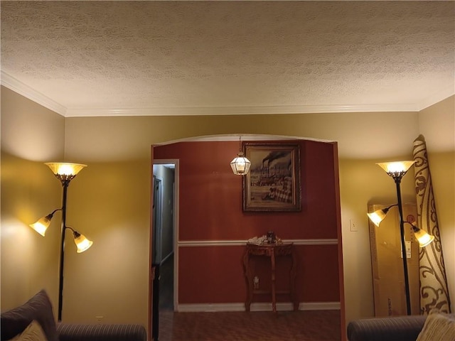 sitting room with crown molding and a textured ceiling