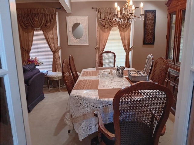 carpeted dining space with a notable chandelier