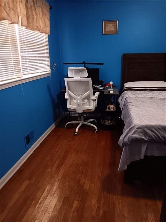 bedroom with wood-type flooring