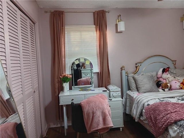 bedroom featuring dark hardwood / wood-style floors and a closet