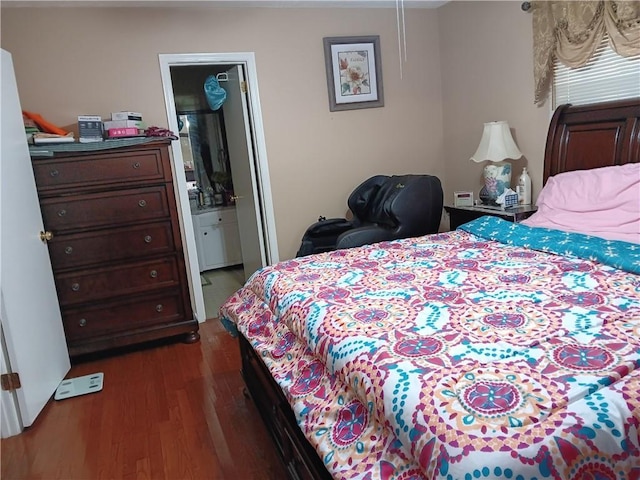 bedroom featuring dark hardwood / wood-style floors and ensuite bath