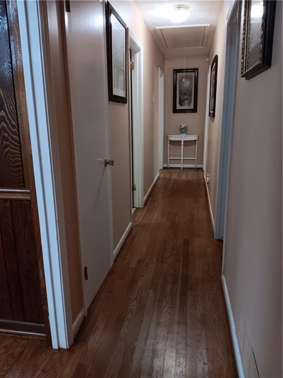 corridor with dark hardwood / wood-style flooring