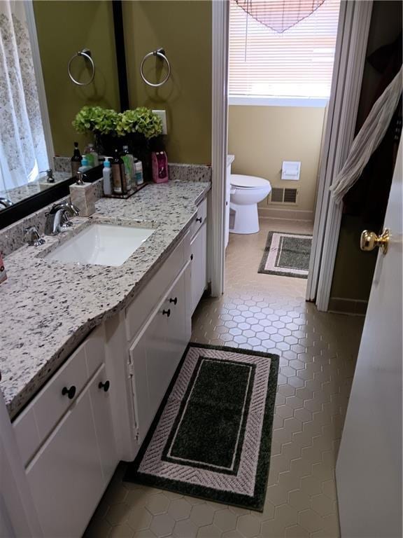 bathroom featuring vanity, toilet, and tile patterned floors